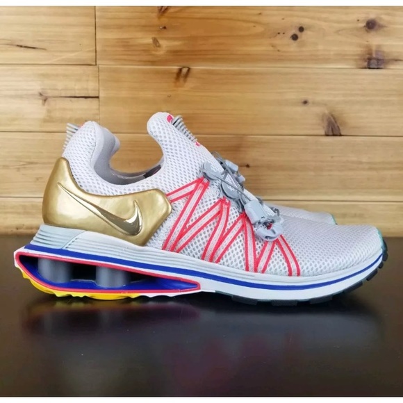 nike shox gravity vast grey metallic gold